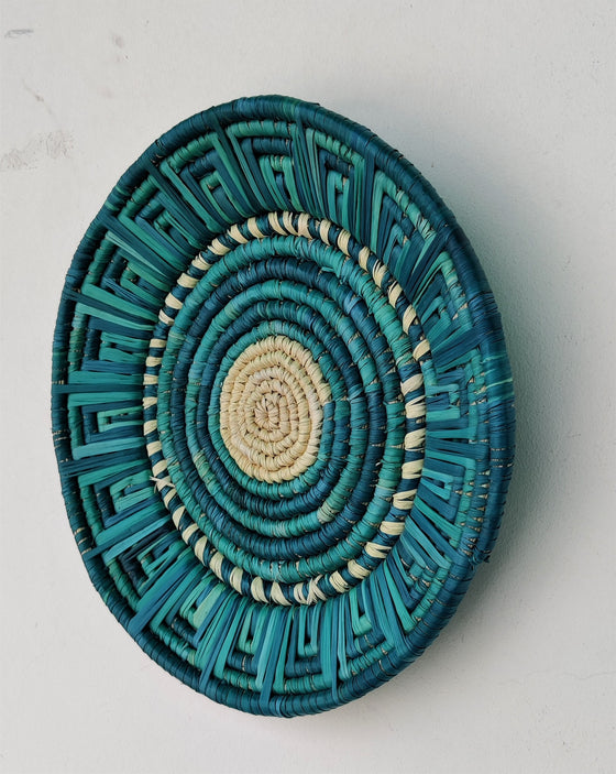 Handwoven artisanal wall mount featuring shades of blue, ocean blue, and yellow