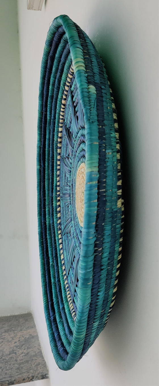 Handwoven artisanal wall mount featuring shades of blue, ocean blue, and yellow