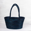 Traditional handwoven picnic basket made from sustainable materials. The basket has an intricate weaving pattern. The basket has sturdy handles for easy transport and is perfect for outdoor picnics, beach trips, or as a stylish storage solution at home.