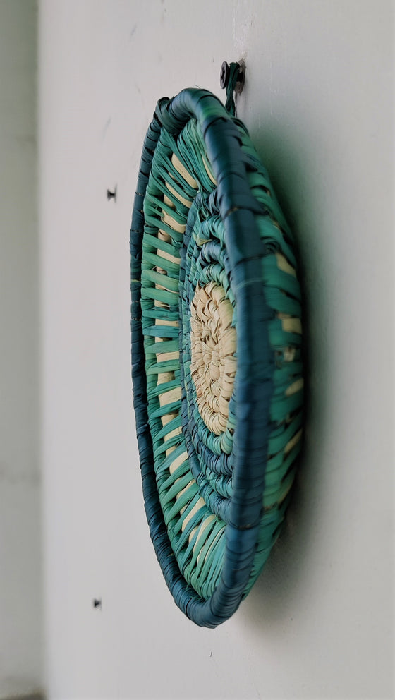 Handwoven artisanal wall mount featuring shades of blue, ocean blue, and yellow