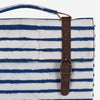 Image of a vegan cork leather i-pad sleeve with indigo stripes and handprinted dabu print design. The sleeve is made of high-quality cork leather that is environmentally friendly and cruelty-free. The front of the sleeve features a unique pattern of indigo stripes and traditional handmade dabu print. The sleeve has a soft lining that protects the device from scratches and other damage. The sleeve has a secure closure and is perfect for carrying an i-pad or other similar-sized tablets.