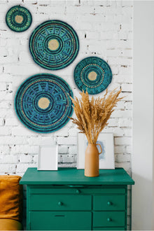  Handwoven artisanal wall mount featuring shades of blue, ocean blue, and yellow