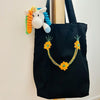Recycled Material, Handmade, Purposeful tote bag. Sustainable and hand embroidered by refugee moms.